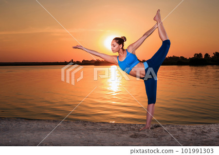 yoga at sunset on the beach. yoga at sunset on the beach. 101991303