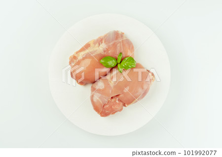 Ogranic food,healthy eating.Food concept.Top view.Raw fresh skinless chicken thigh meat with fresh herbs on a white background.Copy space.Food for retail. 101992077