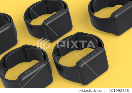 Mockup of smart watches or fitness tracker lying on yellow monochrome background Mockup of smart watches or fitness tracker lying on yellow monochrome background 101992458