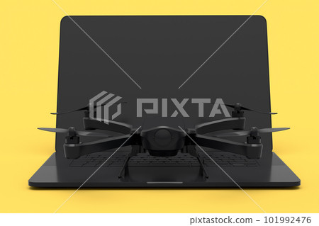 Top view of workspace and photography gear like laptop and drone on yellow 101992476