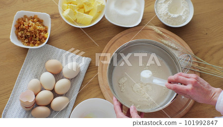 A woman cooking at home, enjoying hobby. Making bread at home. Bread baking. 101992847