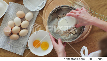 A woman cooking at home, enjoying hobby. Making bread at home. Bread baking. 101992850