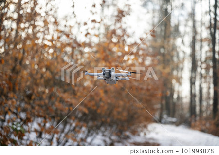 Drone with a camera floating in the air Drone with a camera floating in the air 101993078