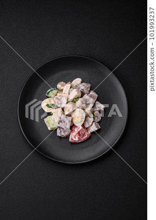 Delicious salad with boiled beef tongue, quail eggs, tomatoes and cucumber 101993237