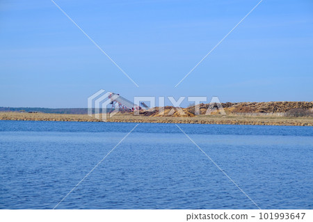 Piles of logs from the timber industry are ready for export. in the distance stacks of logs for export by sea 101993647