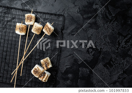 BBQ Grilled Marshmallow on the sticks. Black background. Top view. Copy space BBQ Grilled Marshmallow on the sticks. Black background. Top view. Copy space 101997833