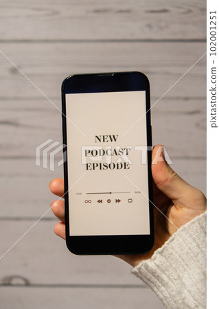 Unrecognizable woman holding mobile phone NEW PODCAST EPISODE listening website page app application with wireless headphones. Audio healing, sound therapy wellness rituals, positive mental health Unrecognizable woman holding mobile phone NEW PODCAST EPISODE listening website page app application with wireless headphones. Audio healing, sound therapy wellness rituals, positive mental health 102001251