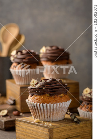 Chocolate chip muffins decorated with chocolate ganache 102002073