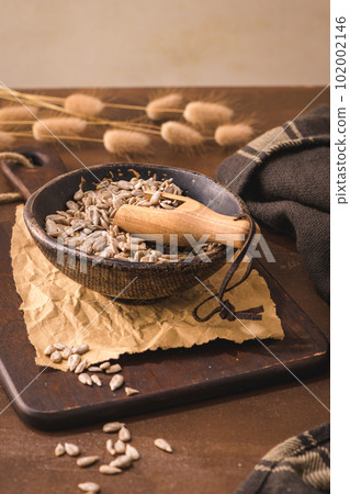 Sunflower seeds in a ceramic bowl 102002146