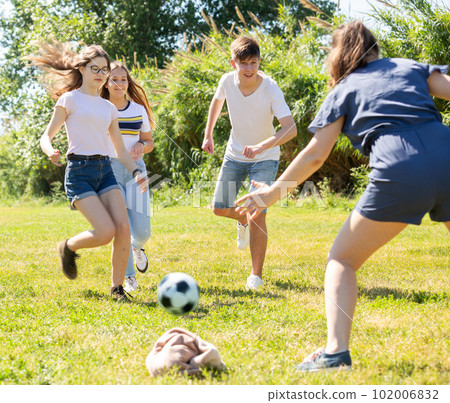 Teenagers play street football with excitement in park Teenagers play street football with excitement in park 102006832