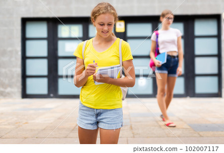 Two young girls going home after school 102007117
