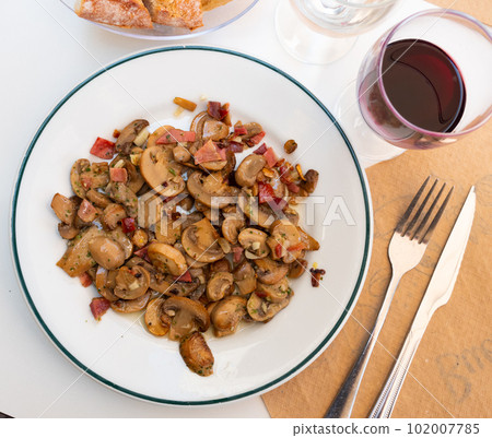 Sauteed Mushrooms served on white plate Sauteed Mushrooms served on white plate 102007785