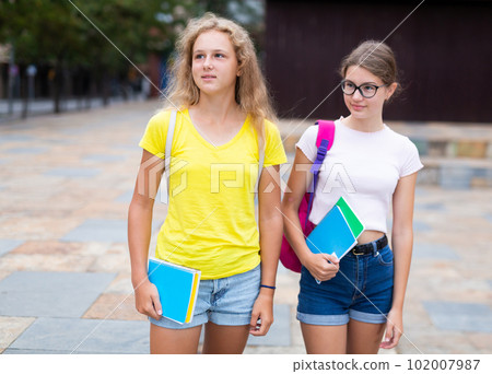 Portrait of two female students walking down street to college Portrait of two female students walking down street to college 102007987