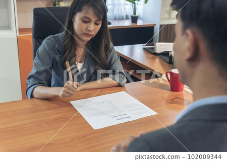 Businessman job interview by human resource HR officer interviwing, talk new employee shaking hands in office with smiling face. HR Manager interview check resume, face to face. Job Interview Concept Businessman job interview by human resource HR officer interviwing, talk new employee shaking hands in office with smiling face. HR Manager interview check resume, face to face. Job Interview Concept 102009344