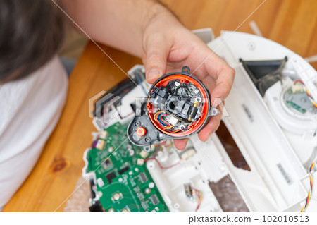 home electronics repair concept. vacuum robot cleaner service center 102010513
