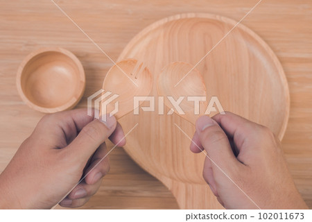 hand holding spoon and fork 102011673
