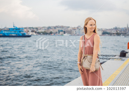 Woman tourist enjoying Galataport area view, cruise port of Istanbul newly opening in 2021, located in the shores of the Galata, Karakoy in Istanbul 102013397