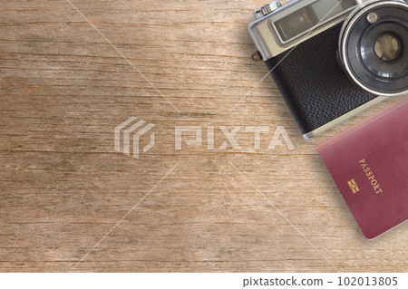 Vintage Camera and Passport on Wooden Background 102013805