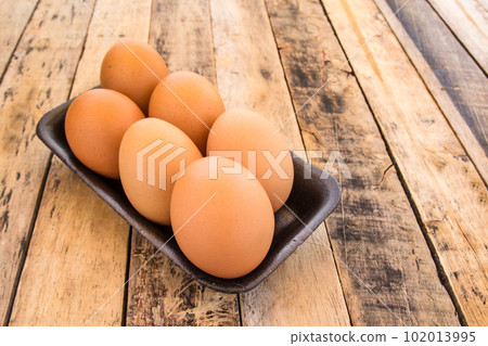 Chicken brown eggs on wooden background Chicken brown eggs on wooden background 102013995