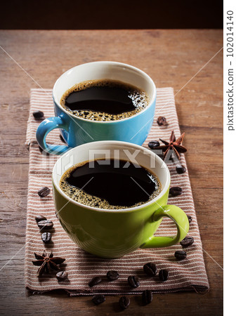 Two cups of coffee on wooden table Two cups of coffee on wooden table 102014140