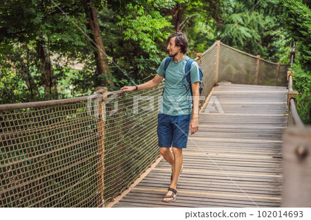 Man tourist in Rope bridge in Yildiz Park. Besiktas, Istanbul, Turkey. Turkiye Man tourist in Rope bridge in Yildiz Park. Besiktas, Istanbul, Turkey. Turkiye 102014693