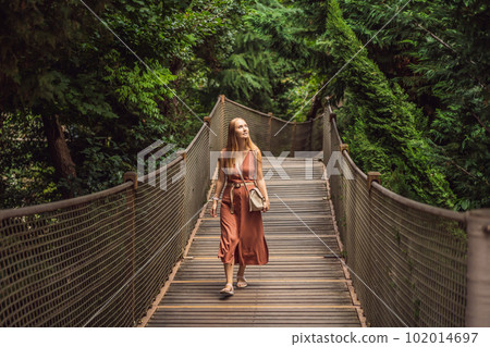 Woman tourist in Rope bridge in Yildiz Park. Besiktas, Istanbul, Turkey. Turkiye Woman tourist in Rope bridge in Yildiz Park. Besiktas, Istanbul, Turkey. Turkiye 102014697