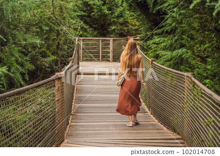 Woman tourist in Rope bridge in Yildiz Park. Besiktas, Istanbul, Turkey. Turkiye Woman tourist in Rope bridge in Yildiz Park. Besiktas, Istanbul, Turkey. Turkiye 102014708