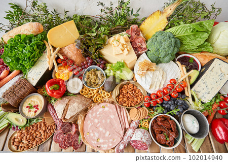 Table full of mediterranean appetizers, tapas or antipasto. Assorted Italian food set. Delicious snack on party or picnic time. Meat and cheese. Italian style banquet. Table full of mediterranean appetizers, tapas or antipasto. Assorted Italian food set. Delicious snack on party or picnic time. Meat and cheese. Italian style banquet. 102014940