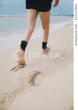 step of woman leg walking forward on sea beach step of woman leg walking forward on sea beach 102014941