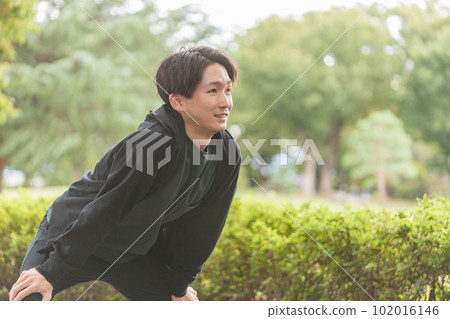 Young Asian man bending, stretching, warming up, warming up before exercise Young Asian man bending, stretching, warming up, warming up before exercise 102016146