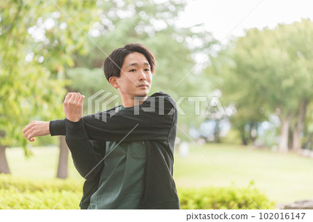 Young Asian man stretching, warming up and warming up before exercise Young Asian man stretching, warming up and warming up before exercise 102016147