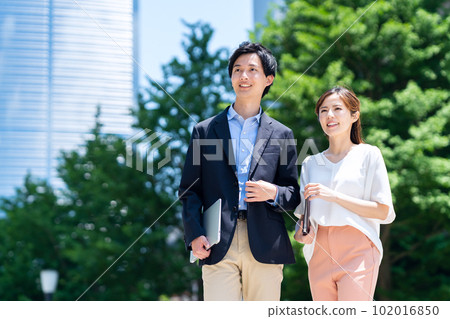 Male and female engineers working in an office district Male and female engineers working in an office district 102016850