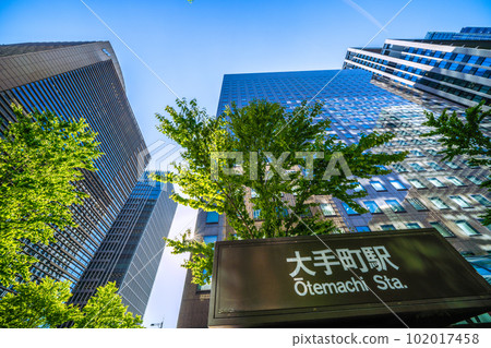 Tokyo cityscape in Japan Sunshine like summer. Otemachi Station in front of the "Otemachi" intersection and skyscrapers shining in the fresh greenery = April 102017458