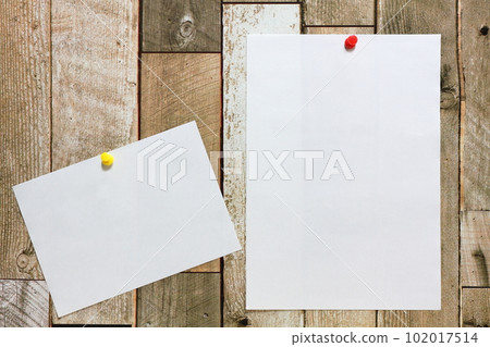 White paper pinned to the wall 102017514