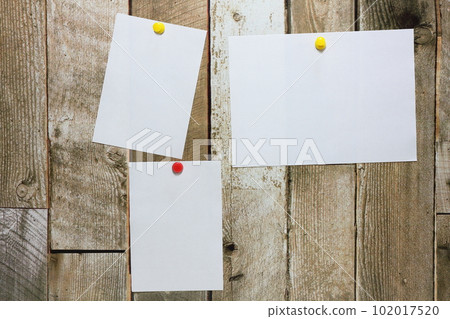 White paper pinned to the wall 102017520