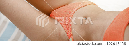 Close up of sexy woman on beach towl in swimsuit with ideal fitness body. Blurred background Close up of sexy woman on beach towl in swimsuit with ideal fitness body. Blurred background 102018438