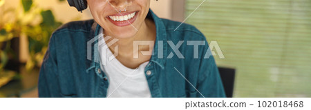 Close up of smiling woman freelancer is working on computer in home office Close up of smiling woman freelancer is working on computer in home office 102018468