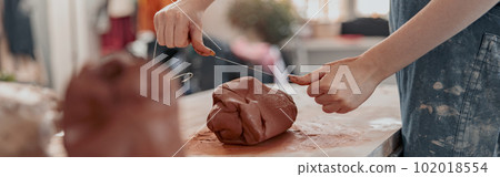 Diligent master molding clay product in ceramics workshop 102018554