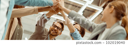 Business people giving five to their colleague in the office Business people giving five to their colleague in the office 102019040