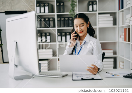 Happy asian business woman have the joy of talking on the smartphone, tablet and laptopon the office .. 102021161