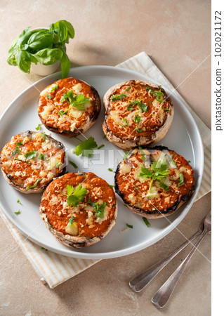 Stuffed champignon portobello stuffed with tomatoes sauce and cheese.  102021172