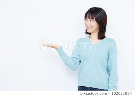 A woman in her thirties making an introduction in front of a white background 102021934