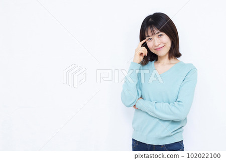 A woman in her thirties making an introduction in front of a white background A woman in her thirties making an introduction in front of a white background 102022100