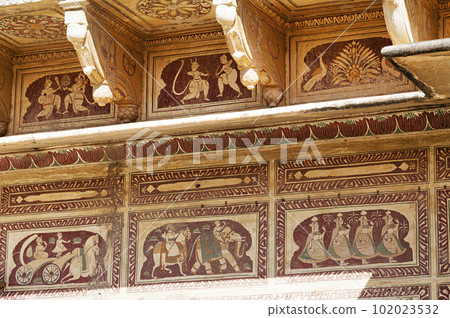 Colourful paintings on the outer wall of Shri Raghunath Ji Ka Bada Mandir, located in Mahansar, Shekhawati, Rajasthan, India 102023532