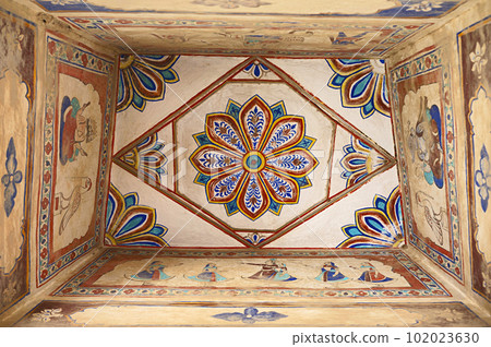 Colourful paintings on the ceiling of an old chhatri (cenotaph), Seth Anantram Podar and family ki smarak rupi chhatri, located in Ramgarh, Shekhawati, Rajasthan, India 102023630