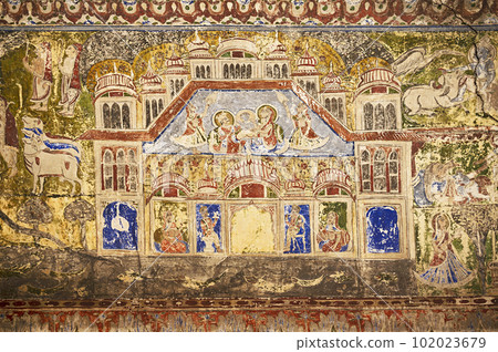 Colourful mythological paintings and mirror work on the ceiling of a small Shani Mandir, located in Ramgarh, Shekhawati, Rajasthan, India 102023679
