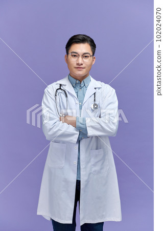 Portrait of young Asian male doctor on blue background 102024070