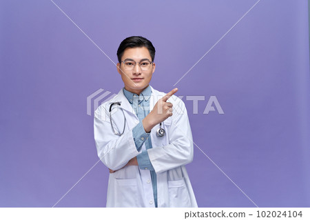 Medical concept of professional male doctor pointing with hand on copy space 102024104