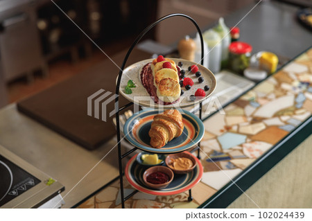 Tray with breakfast at ordering station in open restaurant kitchen 102024439