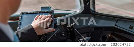 Aircraft pilot sitting in cockpit and using flight display Aircraft pilot sitting in cockpit and using flight display 102024732